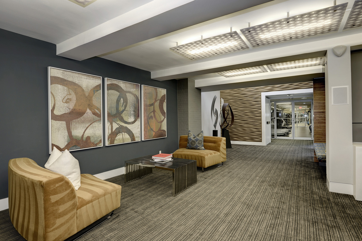 Clubroom hallway with armchairs and abstract art